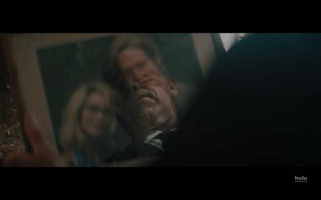 Reprisal S1Ep2 Graham Reflected in Photo of Tommy and Doris